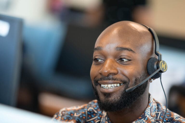 smiling person wearing headset