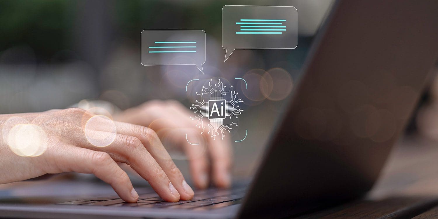 Hands typing on a keyboard with AI helping