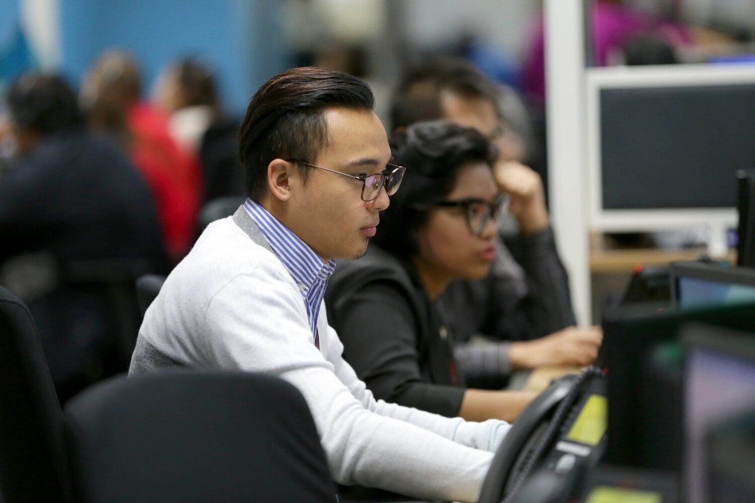 People working in a contact center, helping customers