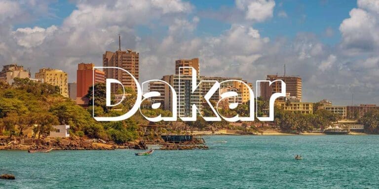 The word "Dakar" is in large over photo of a coastal view
