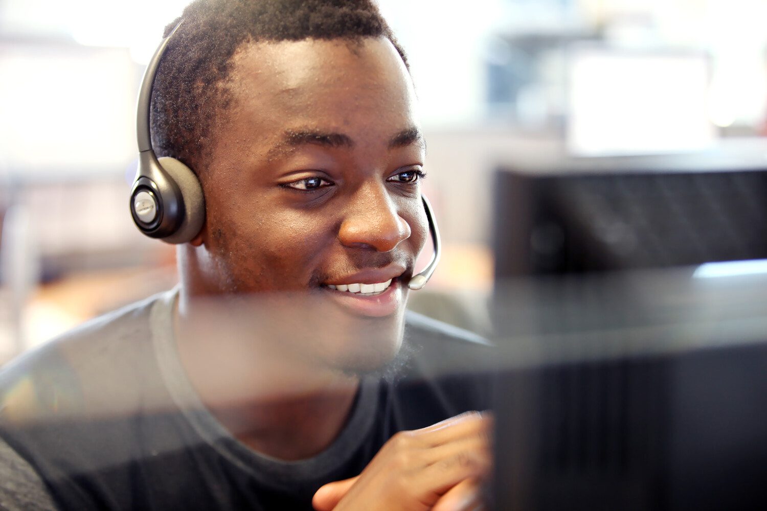 Contact center agent wearing a headset and helping a customer