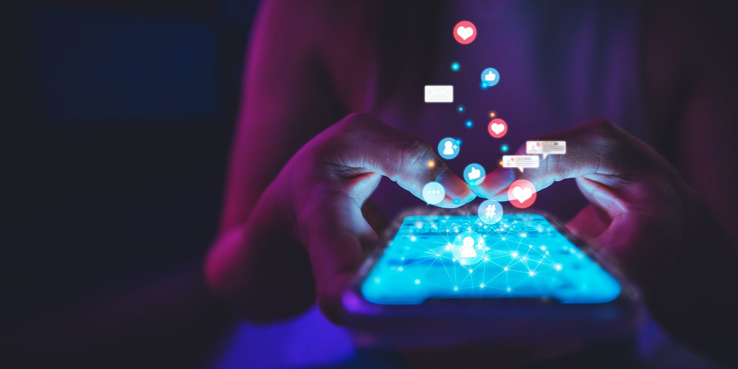 Closeup of hands typing on a smartphone; social media monitoring