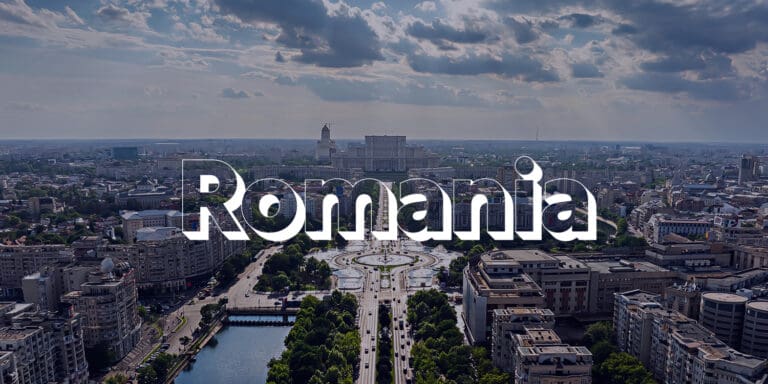 The word "Romania" is displayed across the photo with a cityscape of Romania in the background