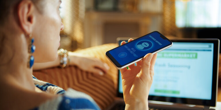 A female holds a smartphone in her hand