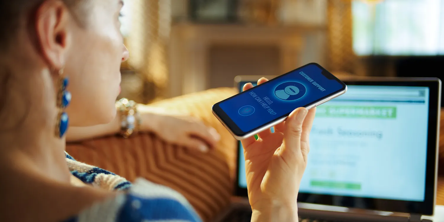 A female holds a smartphone in her hand