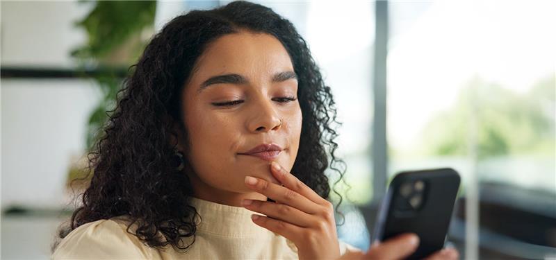 A woman looks at her smartphone