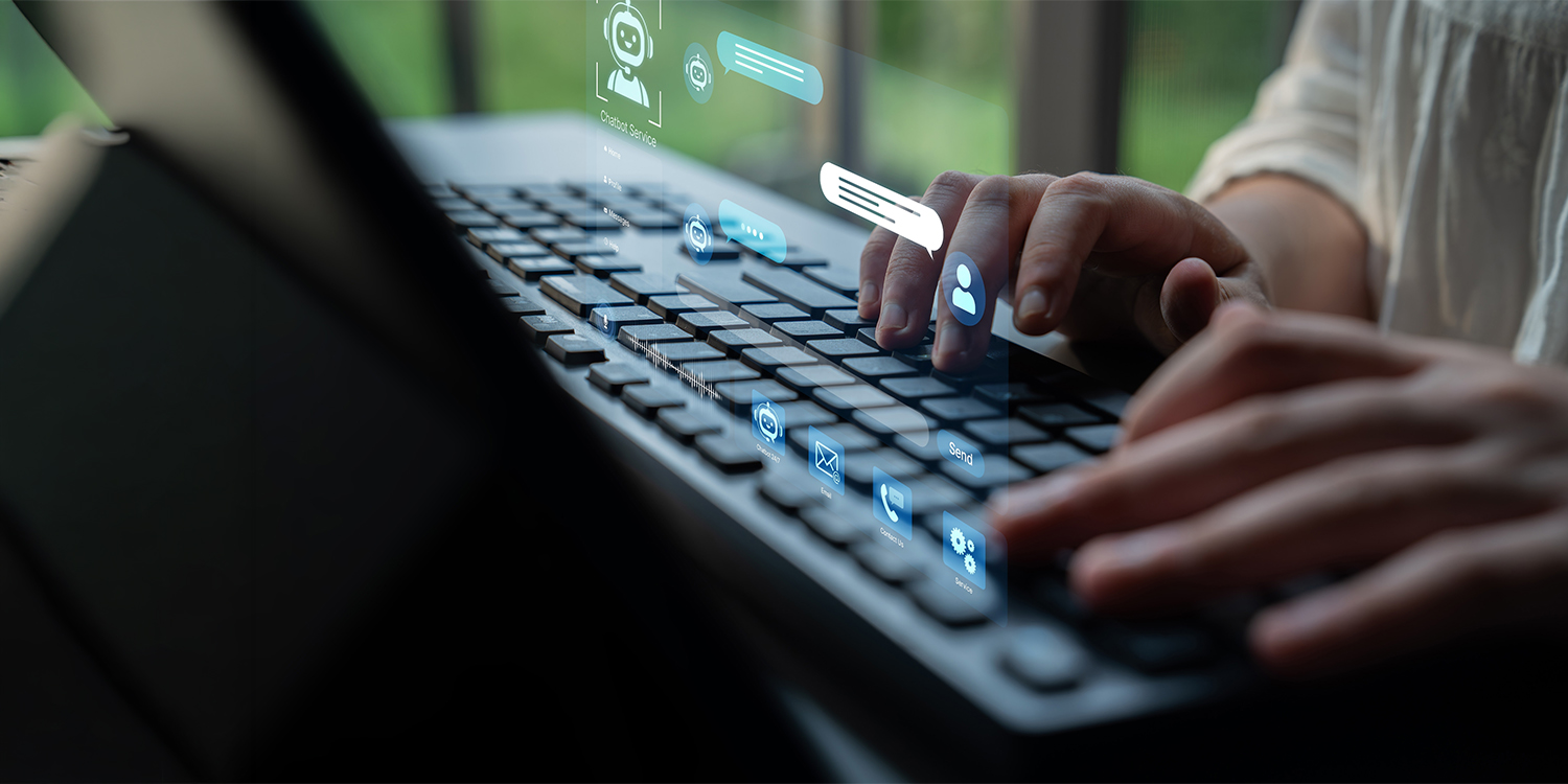 Closeup of a person's hands typing on a computer keyboard