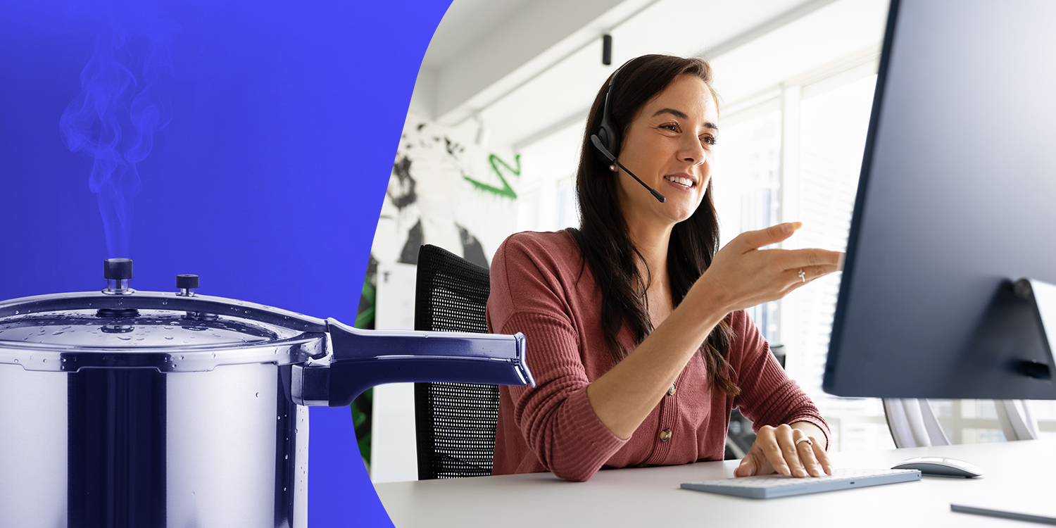 A female agent at a workstation wearing a headset speaks to a customer on a call